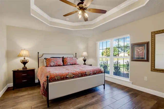 a bedroom with a bed and a chandelier