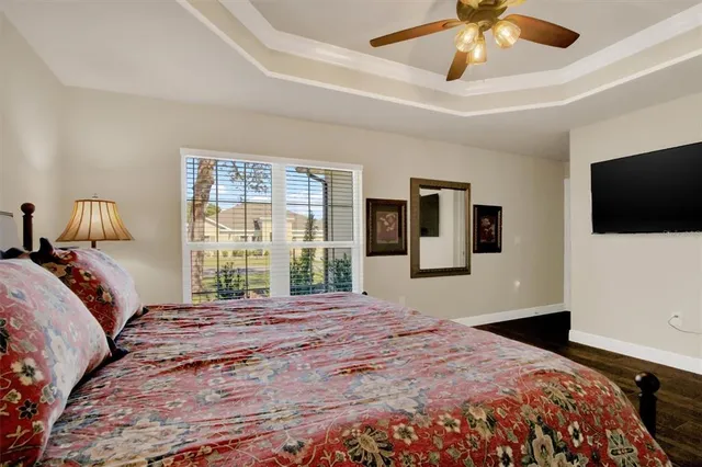 a bedroom with a large bed and a tv