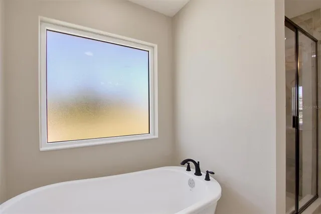 a white bath tub sitting next to a window