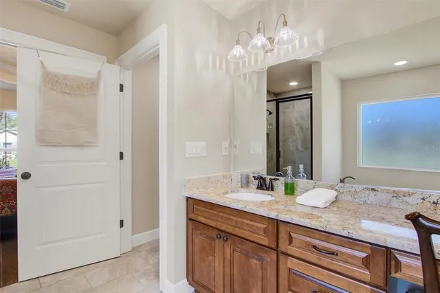 a bathroom with a double vanity sink and a mirror