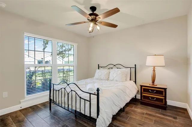 a bedroom with a bed and a chandelier