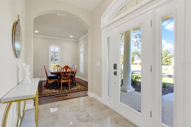 a view of dining room with furniture and front door