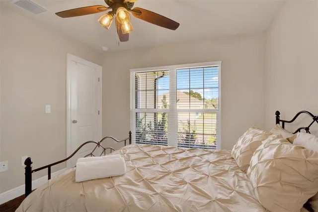 a bedroom with a bed and window