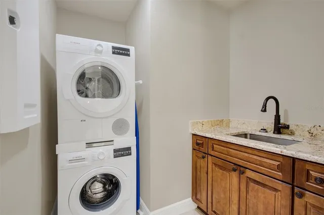 a close view of a sink and washer in a kitchen