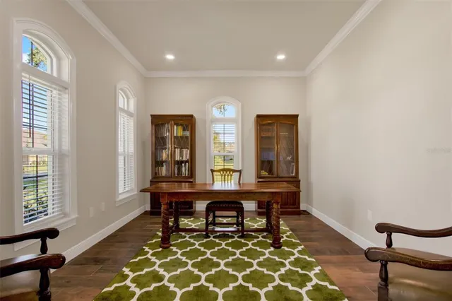 a view of a workspace with furniture and window