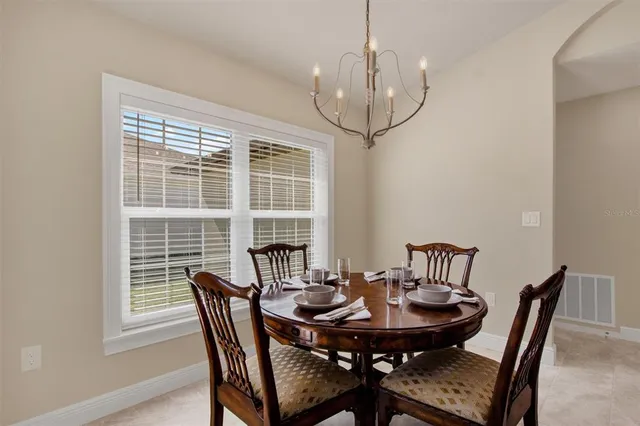 a view of a dining room with furniture window and outside view