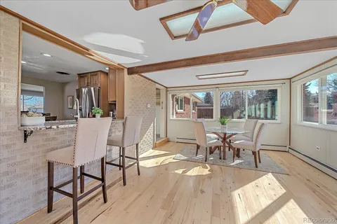 a dining room with furniture a chandelier and wooden floor