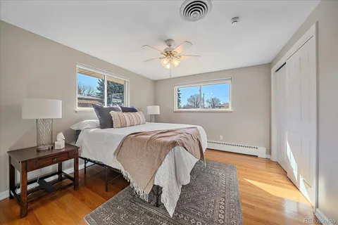 a spacious bedroom with a bed and a lamp