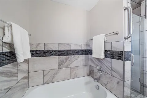 a bathroom with a bathtub and shower