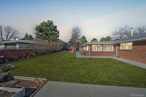 a view of a house with backyard sitting area and garden