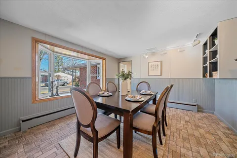 a view of a dining room with furniture and window