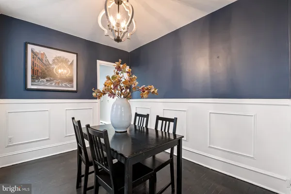 a view of a dining room with furniture and chandelier