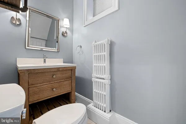 a bathroom with a sink mirror vanity and toilet
