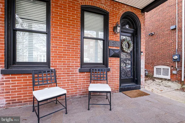a front view of a house with outdoor seating