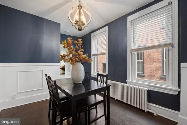 a dining room with furniture and chandelier