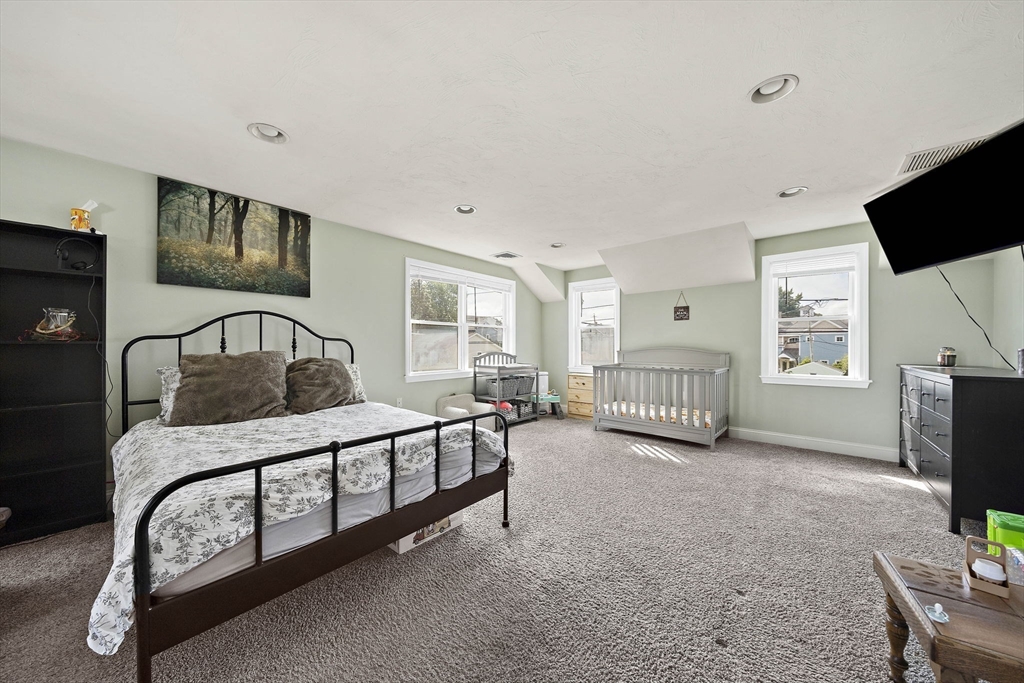92 Spring Street Quincy, MA 02169 - Photo 15 of 34 a bedroom with furniture and a window