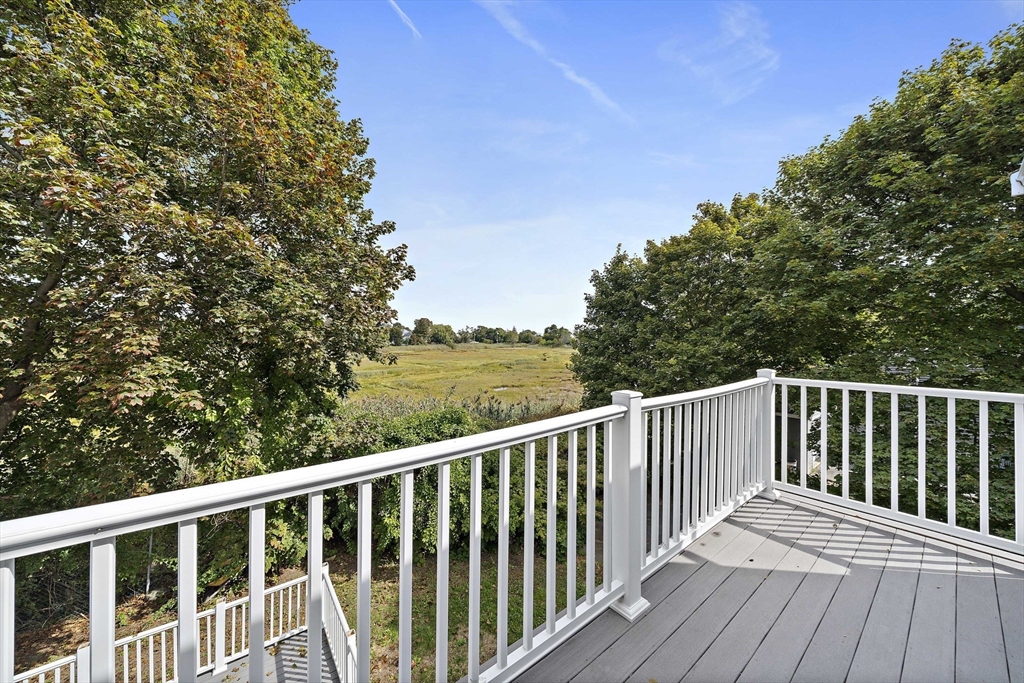 92 Spring Street Quincy, MA 02169 - Photo 16 of 34 a balcony with wooden floor and fence