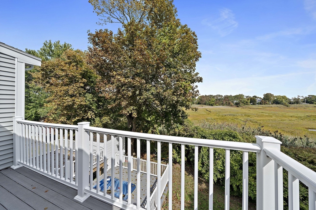 92 Spring Street Quincy, MA 02169 - Photo 17 of 34 a balcony with wooden floor and fence