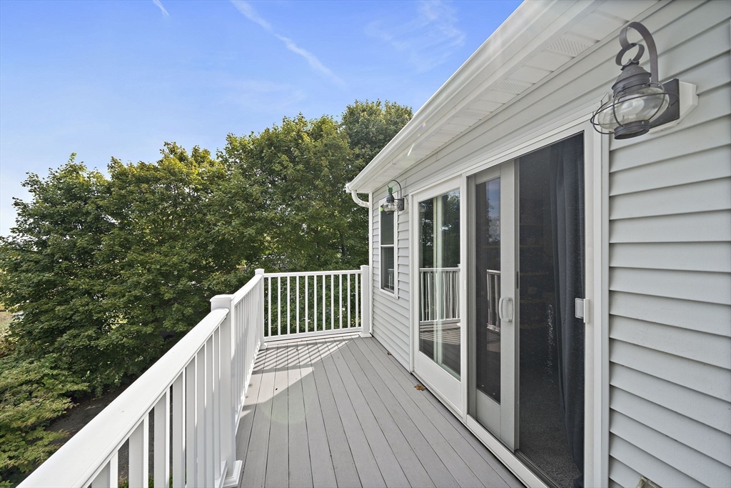 92 Spring Street Quincy, MA 02169 - Photo 18 of 34 a balcony with wooden floor and fence