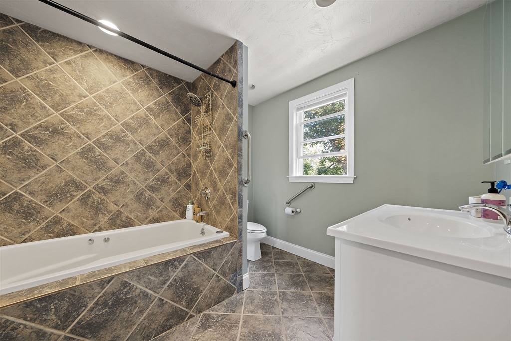 92 Spring Street Quincy, MA 02169 - Photo 19 of 34 a bathroom with a bathtub and a shower