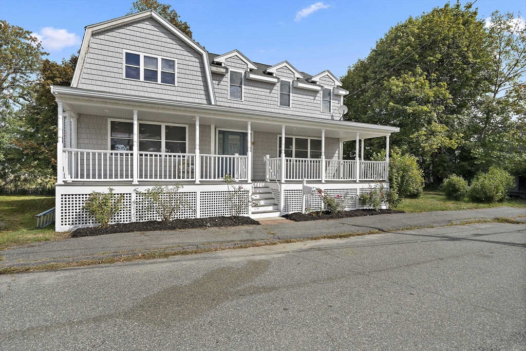 92 Spring Street Quincy, MA 02169 - Photo 3 of 34 a front view of a house with a garden