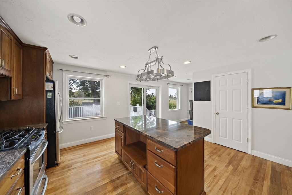 92 Spring Street Quincy, MA 02169 - Photo 5 of 34 a kitchen with kitchen island granite countertop a sink appliances and cabinets
