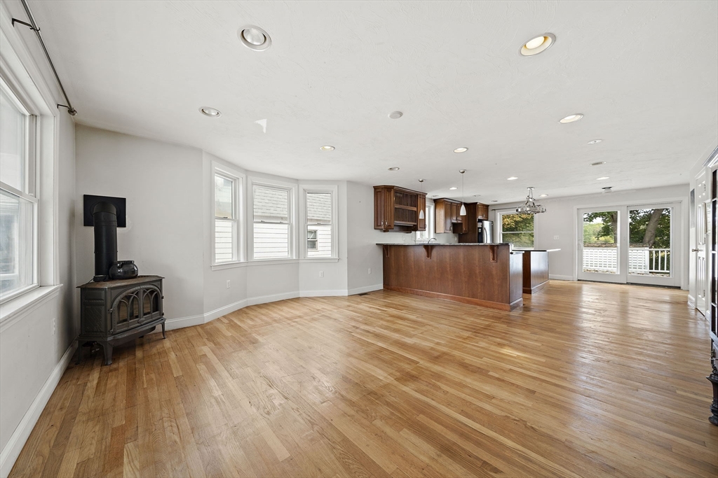 92 Spring Street Quincy, MA 02169 - Photo 10 of 34 a big room with wooden floor and windows