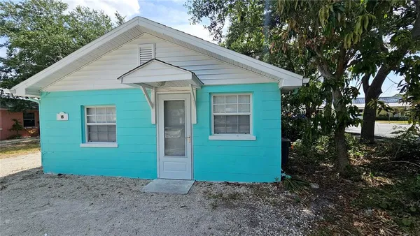 a view of a small house with a small yard