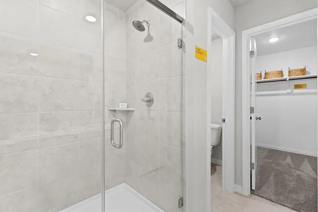 a bathroom with a shower and a glass door