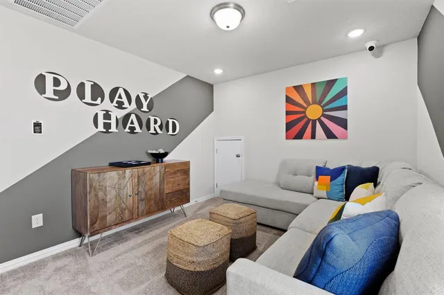 a living room with furniture and wall paintings