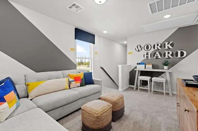 a living room with furniture and kitchen view
