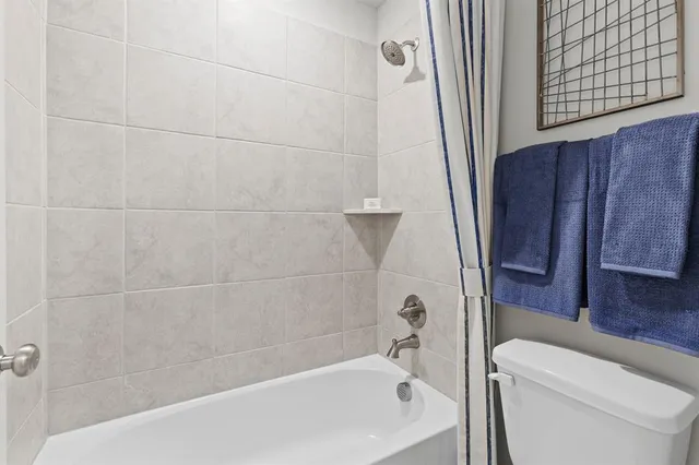 a bathroom with a bathtub and a toilet