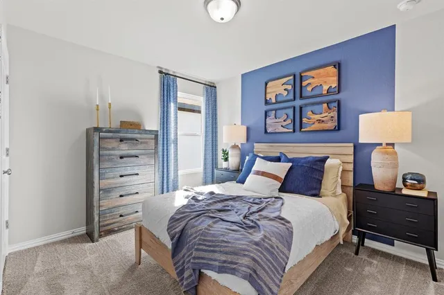 a bedroom with a bed and a night stand