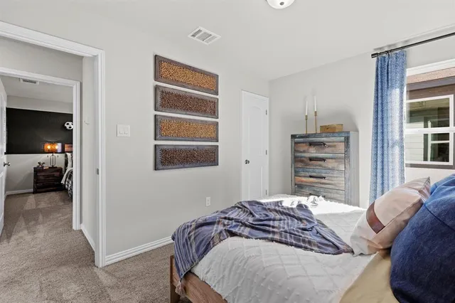 a bedroom with a bed and a large mirror