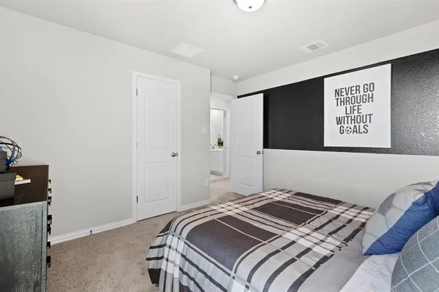 a bedroom with a bed and a tv