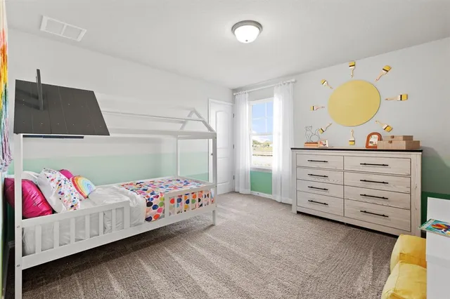 a bedroom with a bed and a dresser