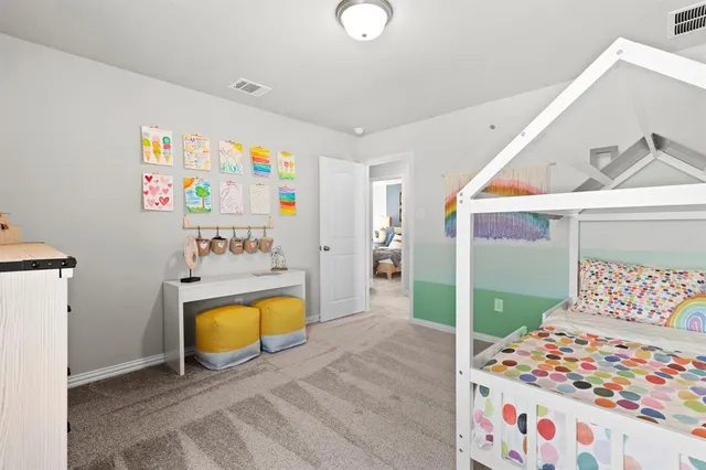 a view of a bedroom with bed and toys