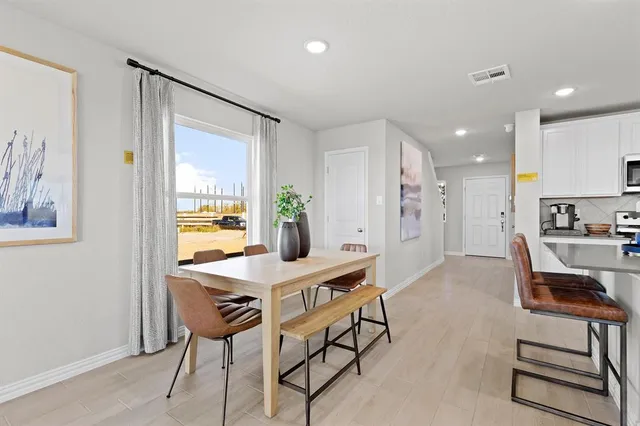 a view of a dining room with furniture and a window