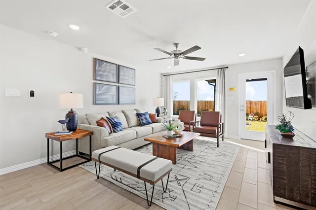a living room with furniture and a flat screen tv