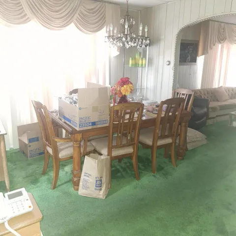 a view of a dining room with furniture and chandelier