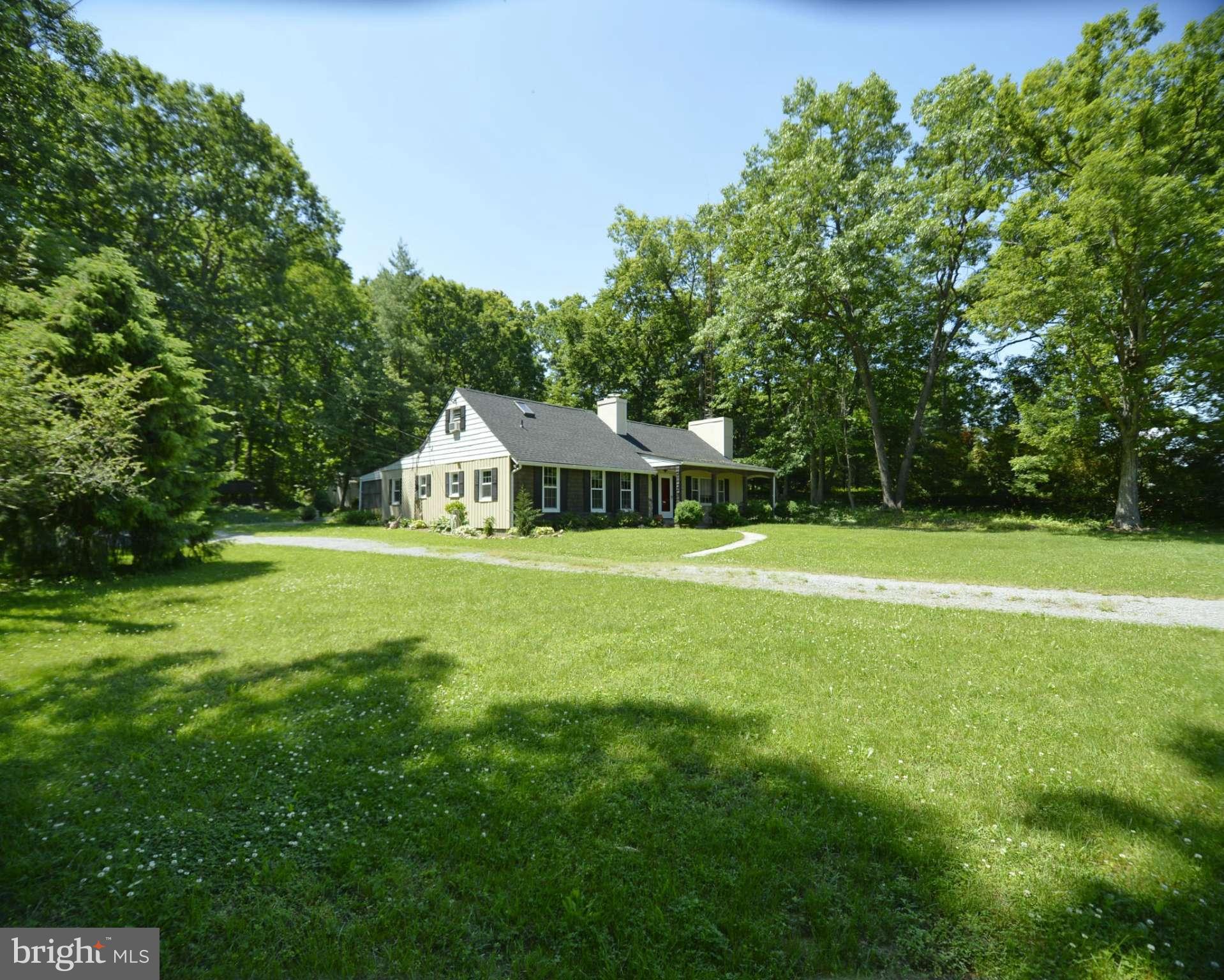 6446 Howellsville Road Front Royal, VA 22630 - Photo 3 of 30 a view of a house with a big yard and large trees