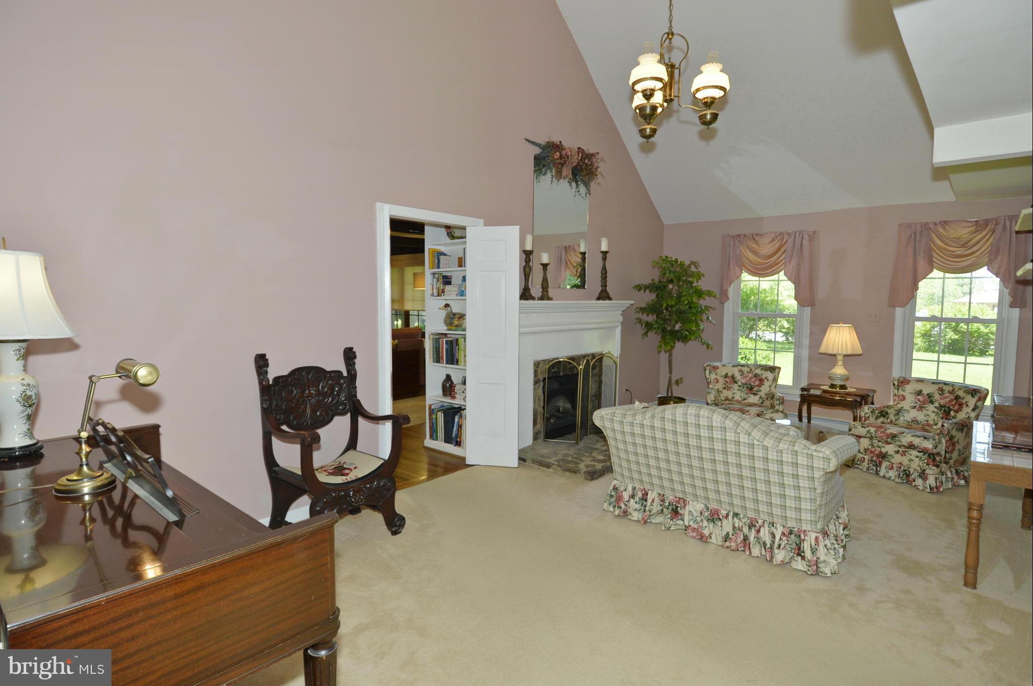 6446 Howellsville Road Front Royal, VA 22630 - Photo 22 of 30 a living room with furniture chandelier and a fireplace