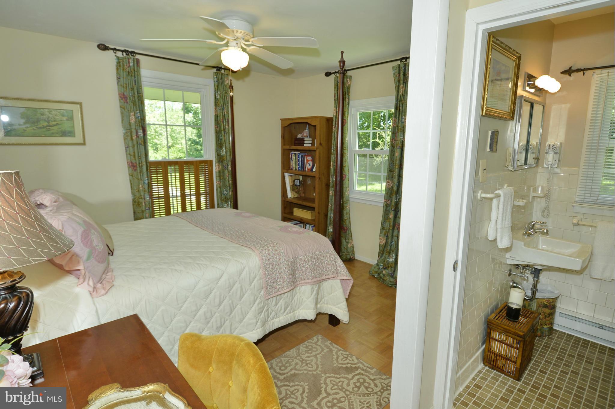 6446 Howellsville Road Front Royal, VA 22630 - Photo 23 of 30 a bedroom with a bed and a chandelier