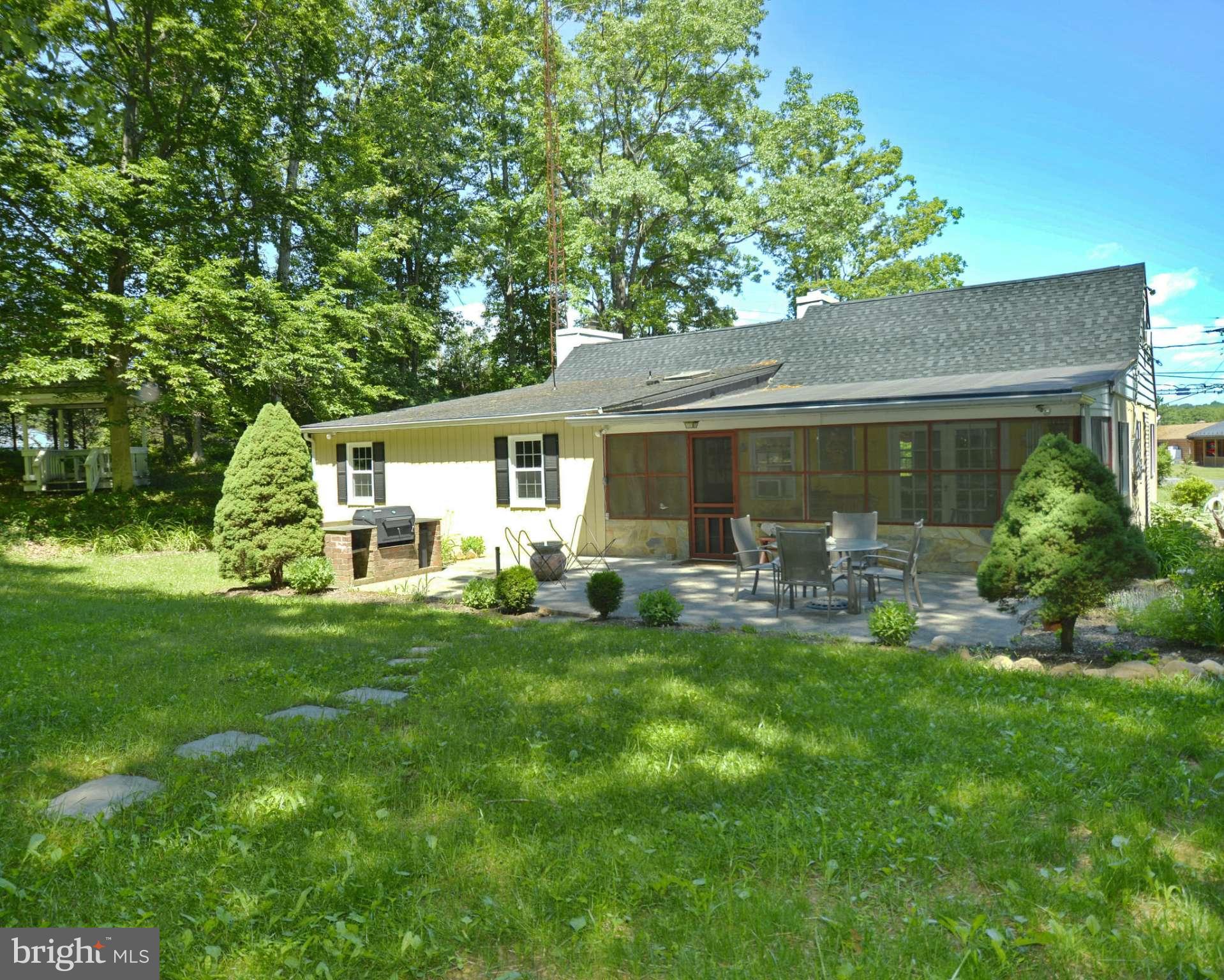 6446 Howellsville Road Front Royal, VA 22630 - Photo 4 of 30 a front view of house with yard and outdoor seating