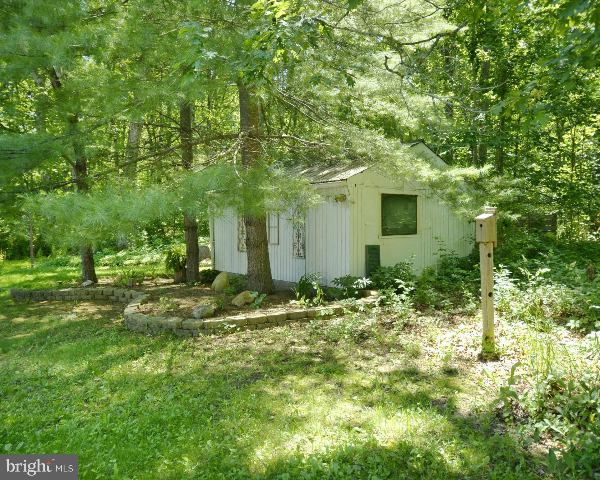 6446 Howellsville Road Front Royal, VA 22630 - Photo 10 of 30 a backyard of a house with table and chairs