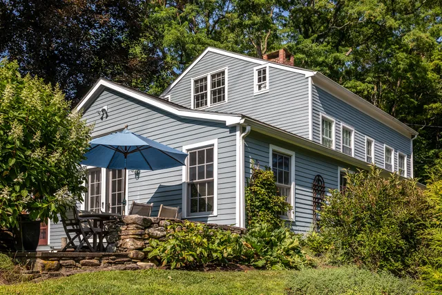 a bedroom with a bed chair and fireplace