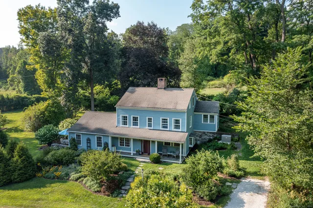 a front view of house with yard and green space