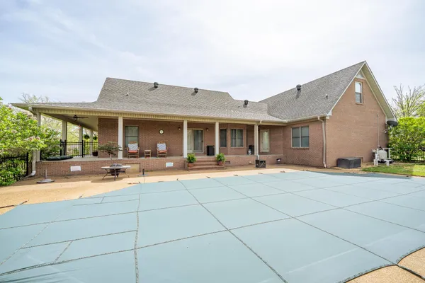 a view of a house with sitting area and swimming pool