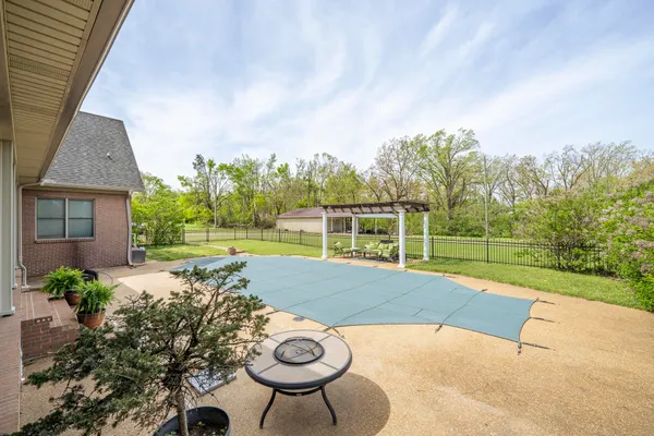 a view of a swimming pool with a patio