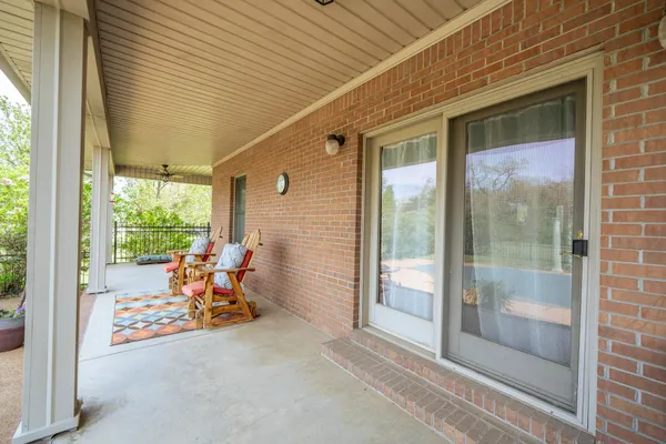 a view of a room with a large window and sitting area